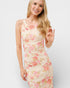 Woman wearing a floral dress on a plain background