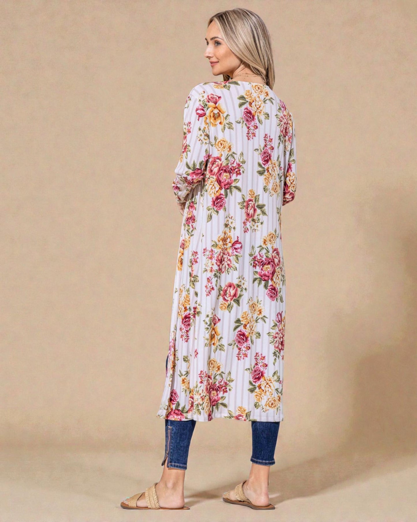 Woman wearing a floral dress against a beige background