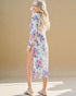 Woman wearing a floral dress with a beige background