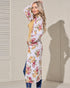 Woman wearing a floral dress with a neutral background