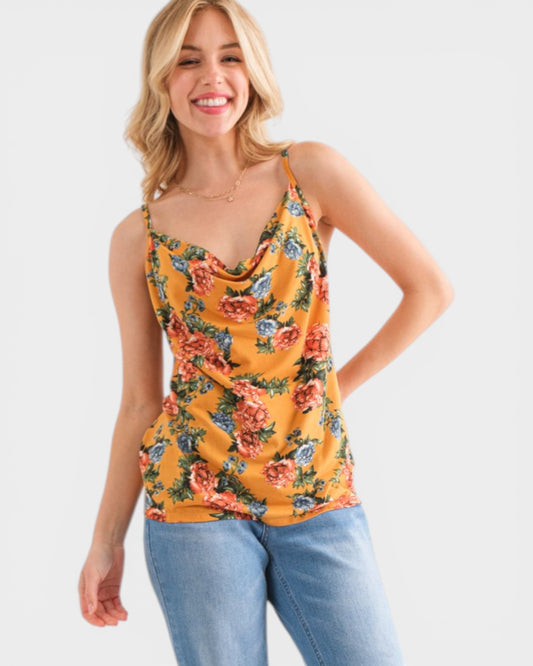 Woman wearing a floral tank top and jeans on a white background