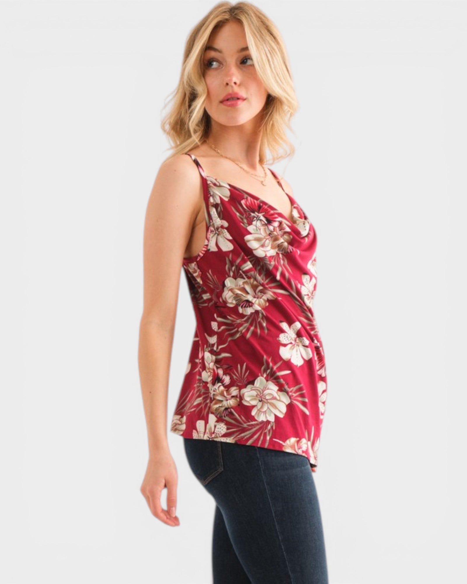 Woman wearing a red floral tank top on a white background