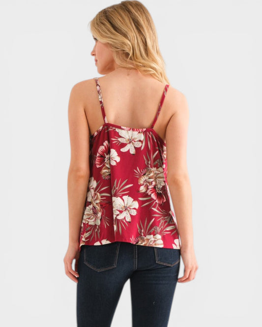 Woman wearing a red floral top on a white background