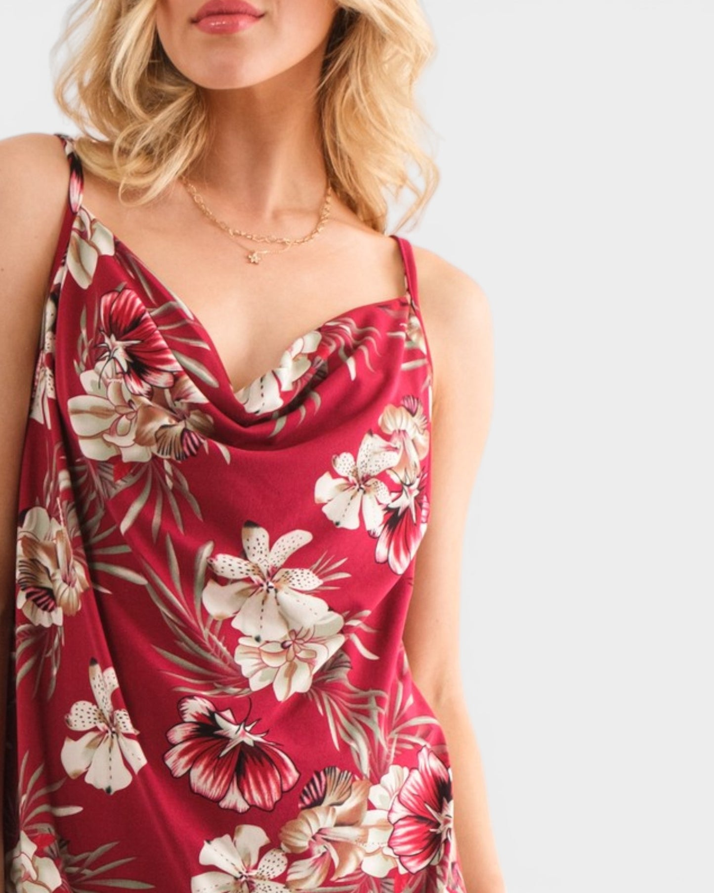 Woman wearing a red floral dress on a white background