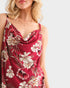 Woman wearing a red floral dress on a white background