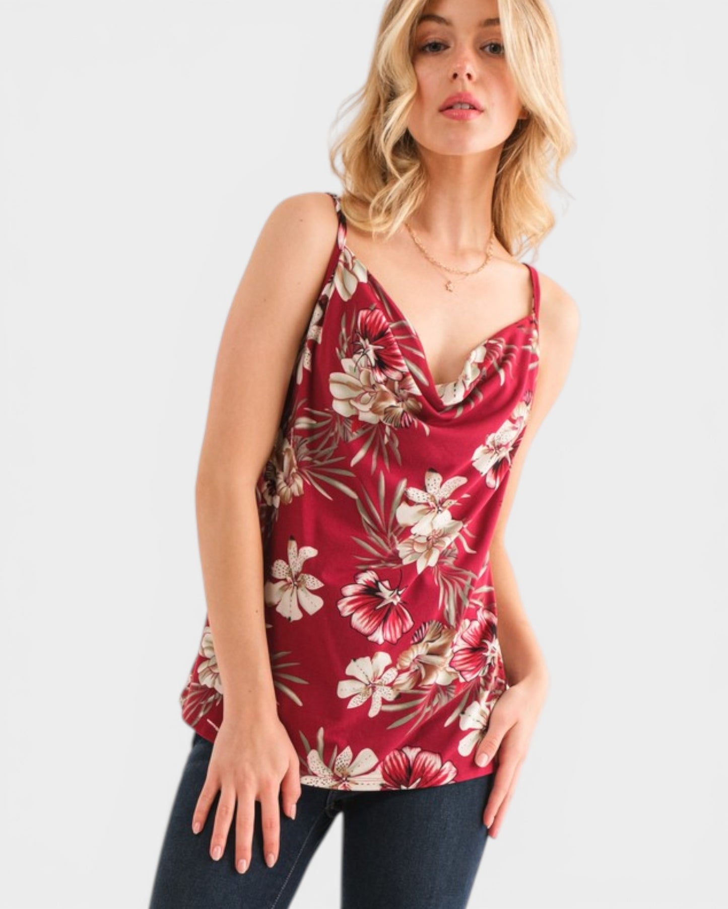 Woman wearing a red floral tank top on a white background