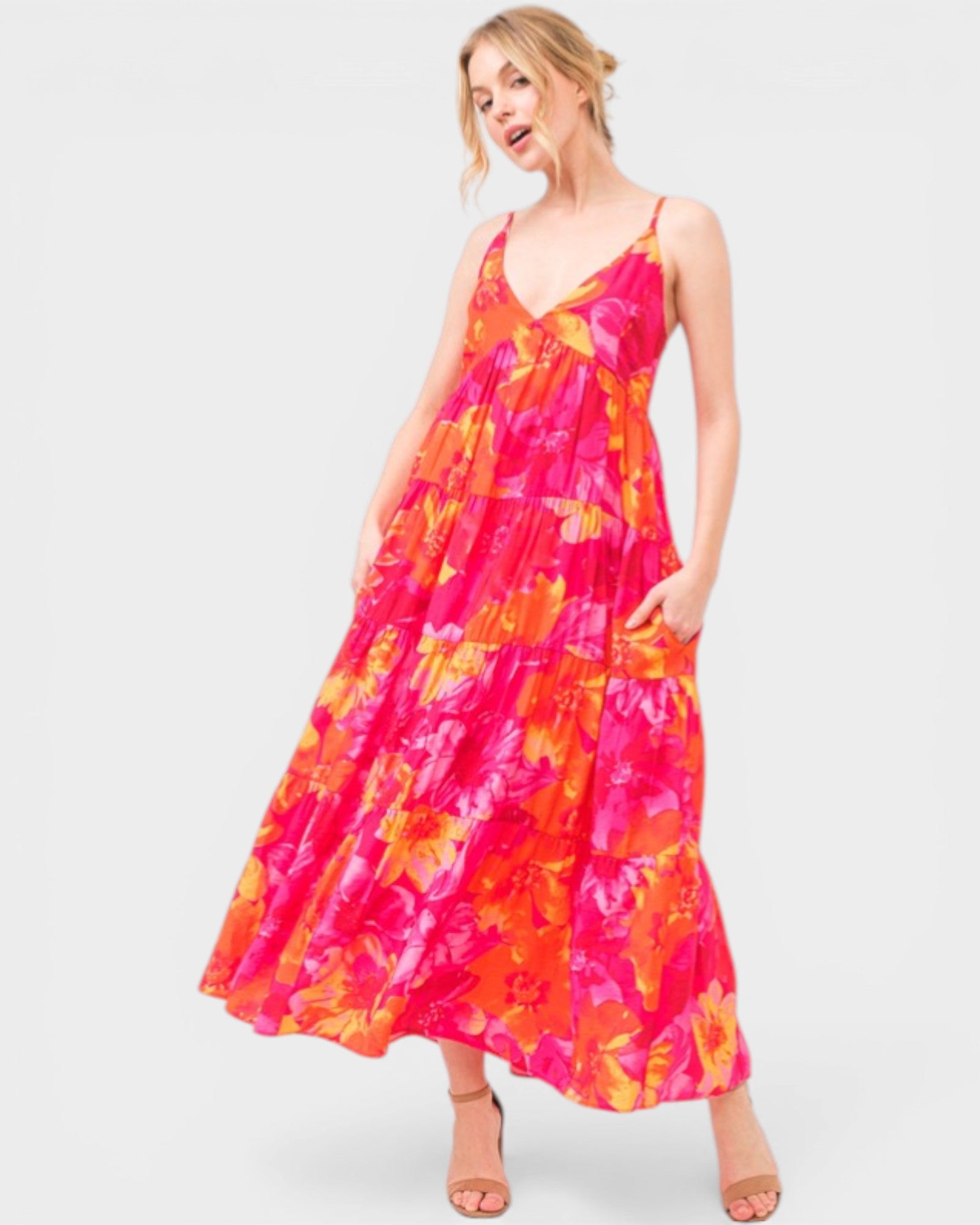 Woman wearing a colorful floral dress on a white background