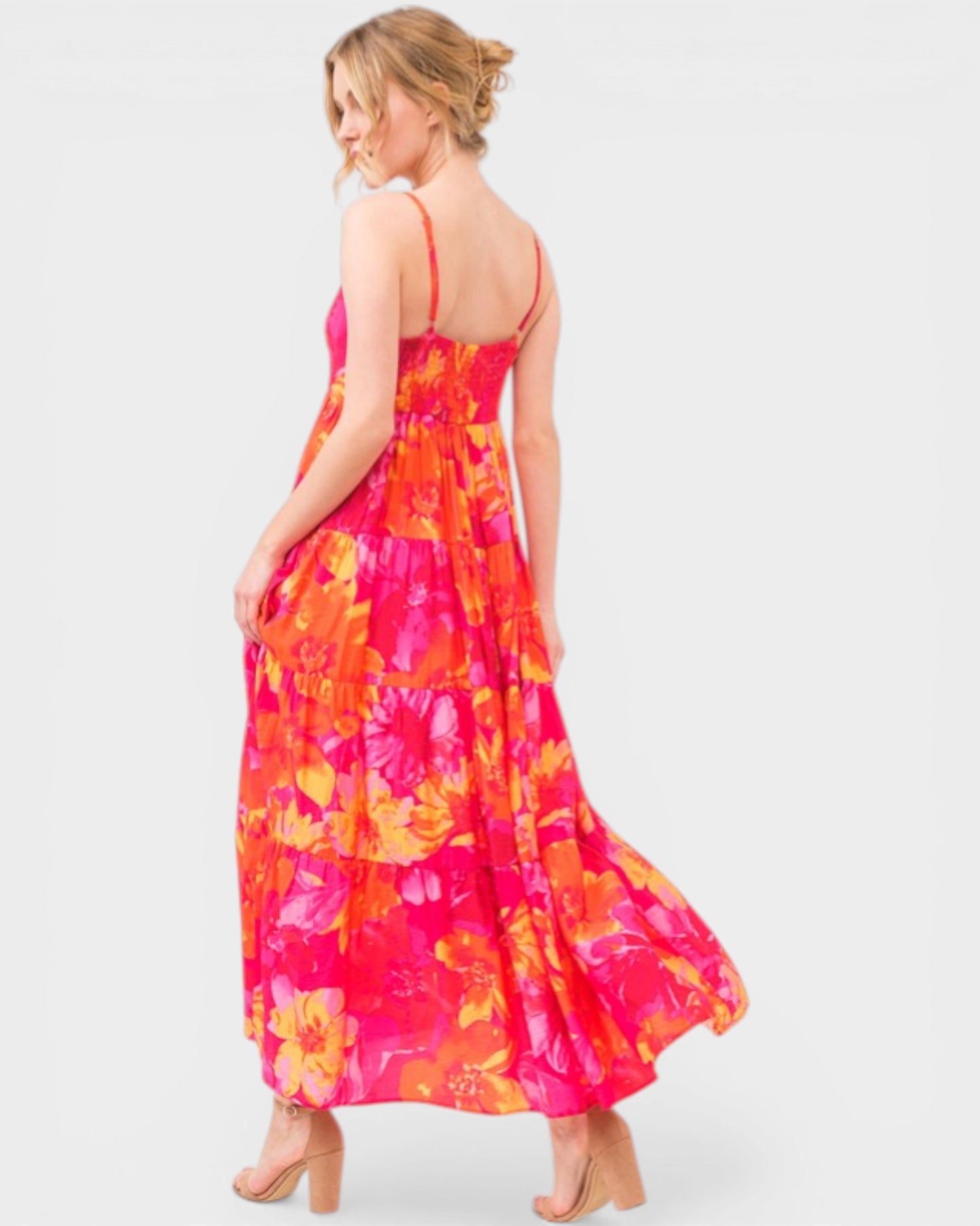 Woman wearing a colorful floral dress on a white background