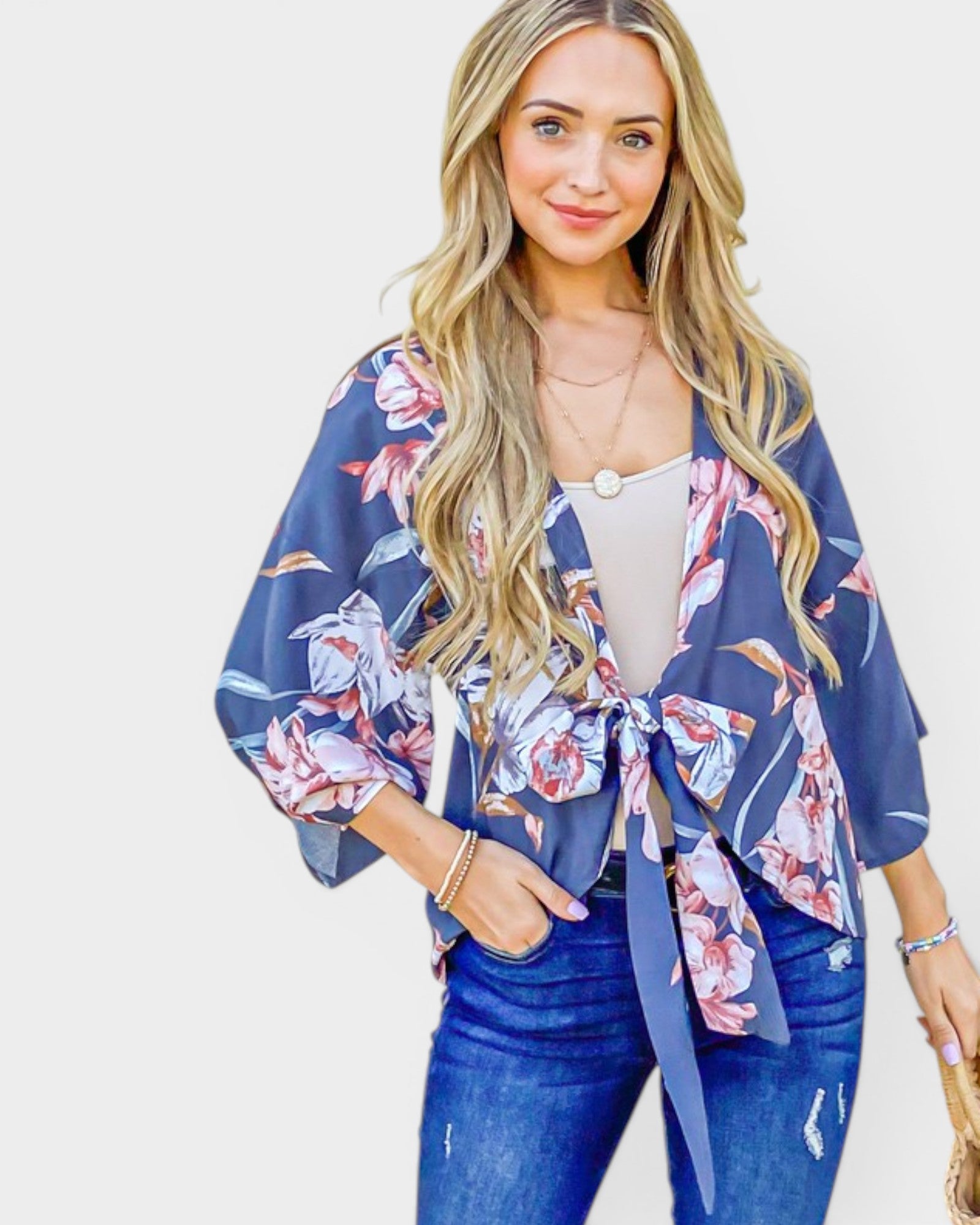 Woman wearing a blue floral kimono with a plain background