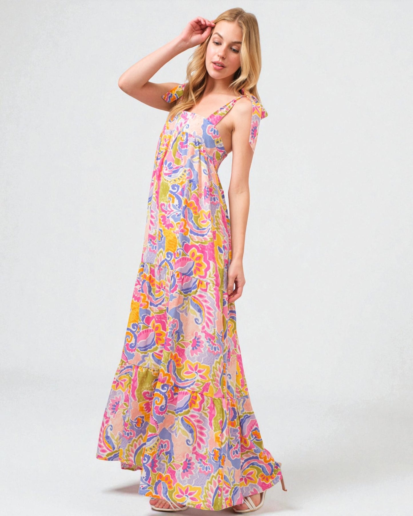 Woman wearing a colorful floral dress on a white background