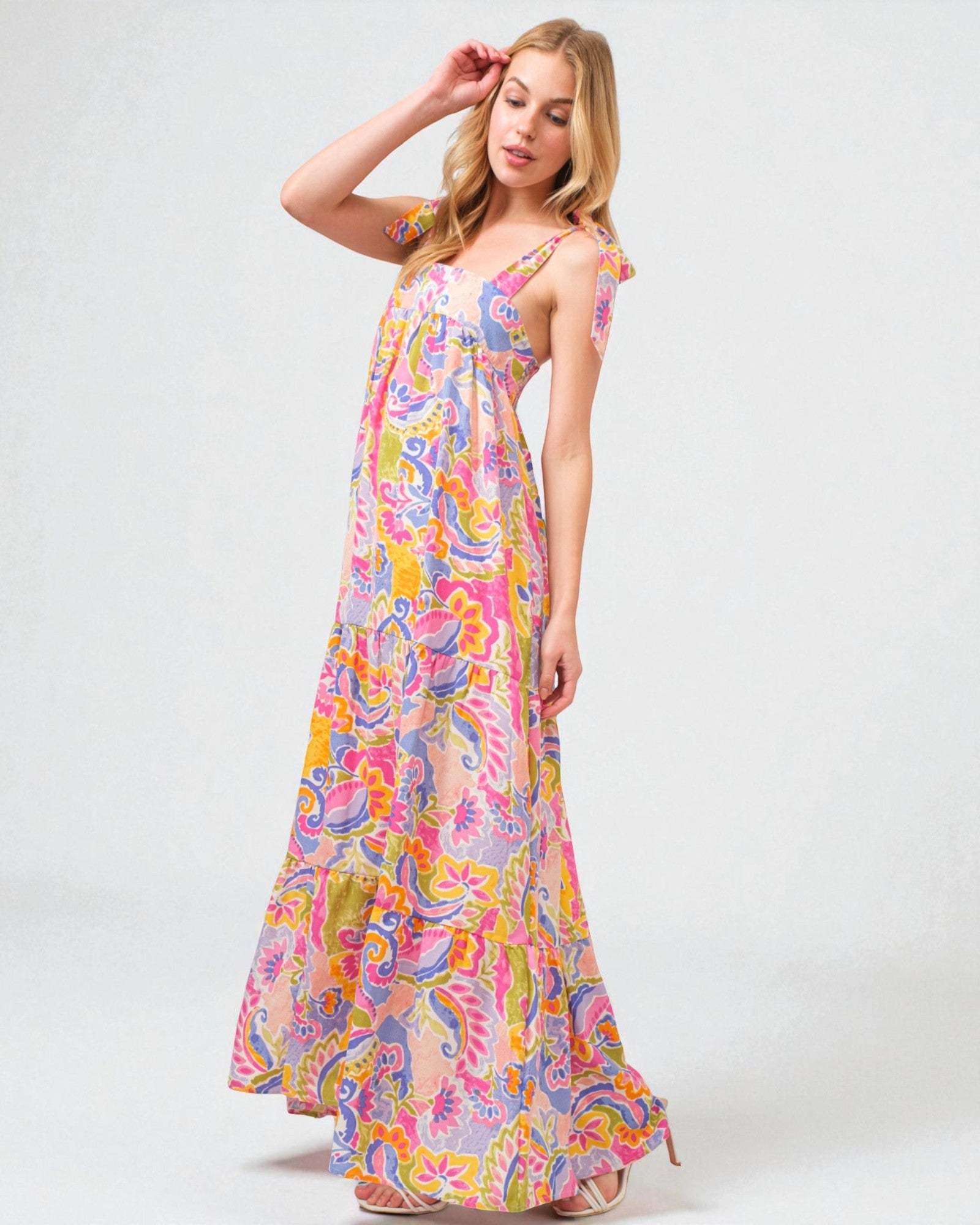 Woman wearing a colorful floral dress on a white background