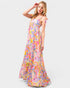 Woman wearing a colorful floral dress on a white background