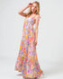 Woman wearing a colorful floral dress on a white background