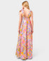 Woman wearing a colorful floral dress on a white background