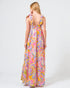 Woman wearing a colorful paisley dress on a white background