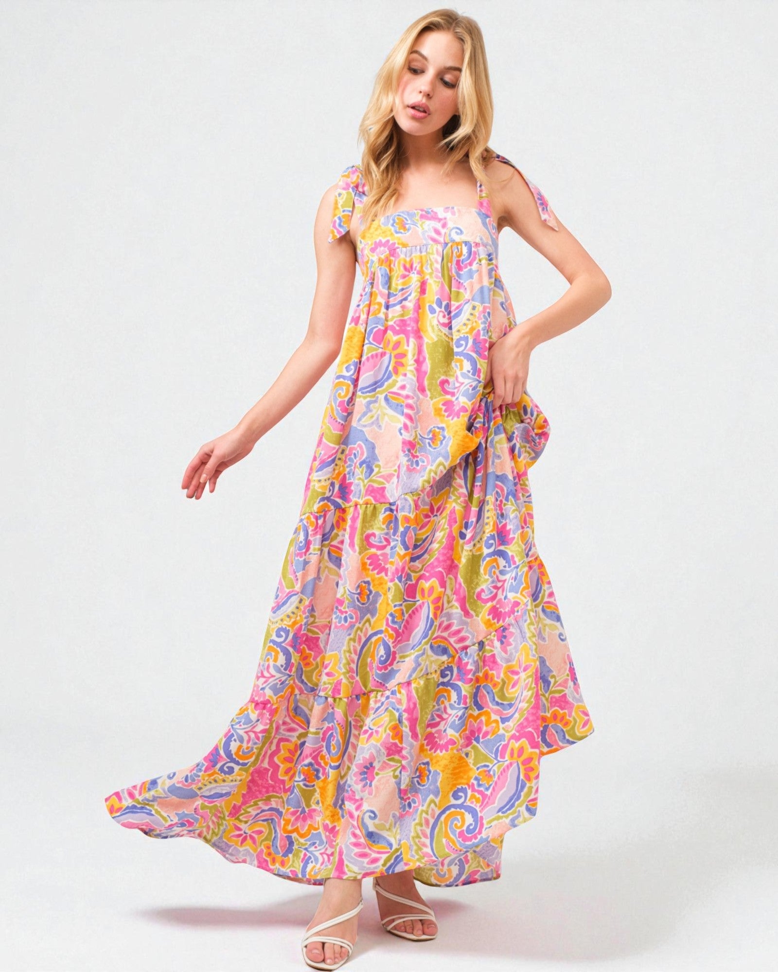 Woman wearing a colorful floral dress on a white background