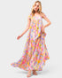 Woman wearing a colorful floral dress on a white background