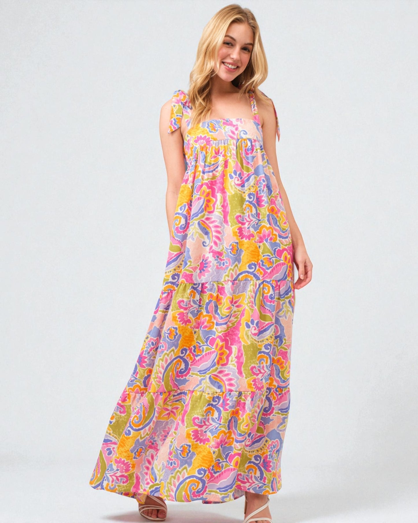 Woman wearing a colorful patterned dress on a white background