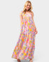 Woman wearing a colorful floral dress on a white background