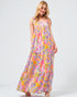 Woman wearing a colorful patterned dress on a white background