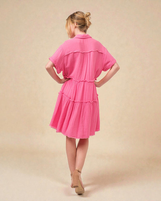 Woman wearing a pink dress against a beige background