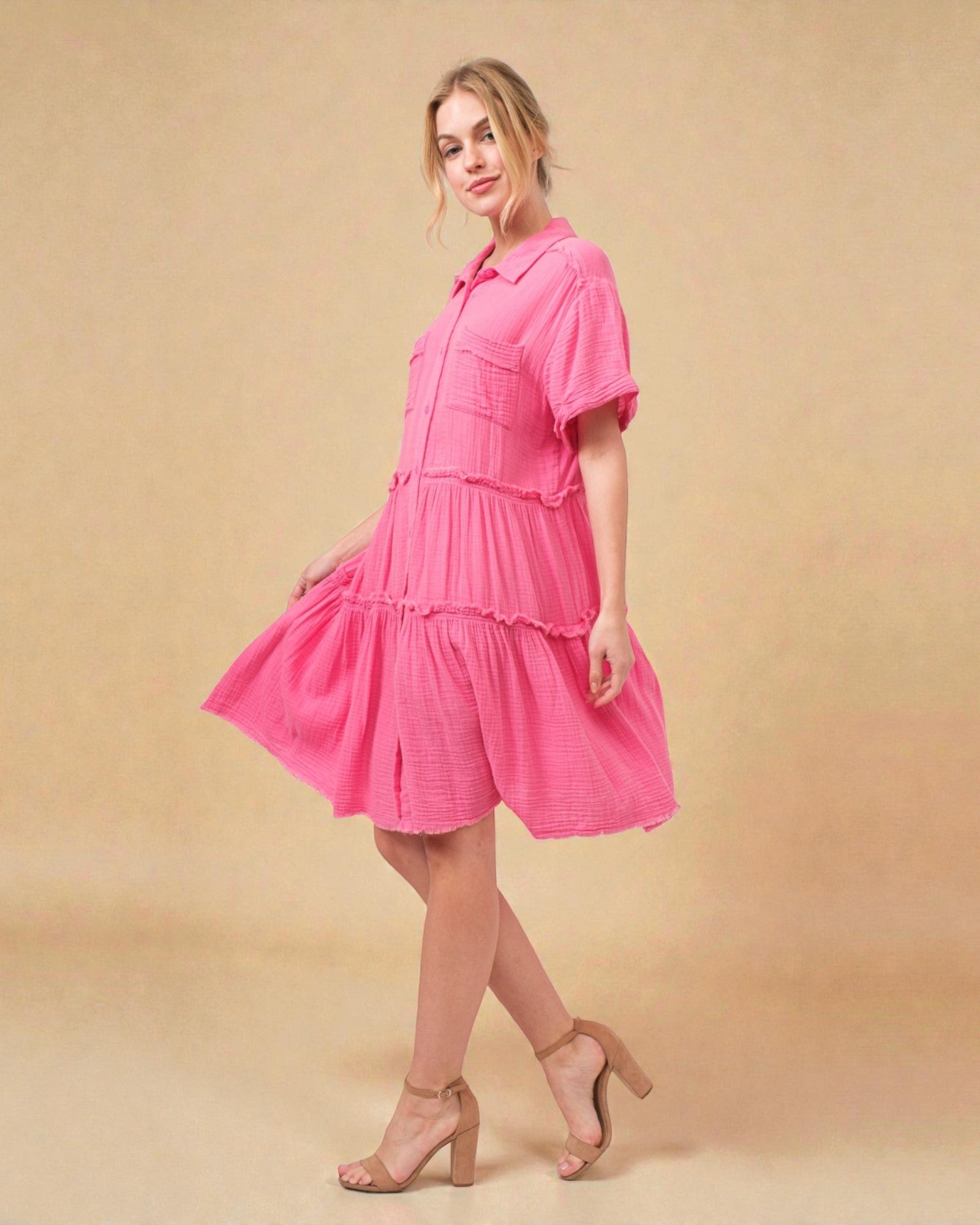 Woman wearing a pink dress against a beige background