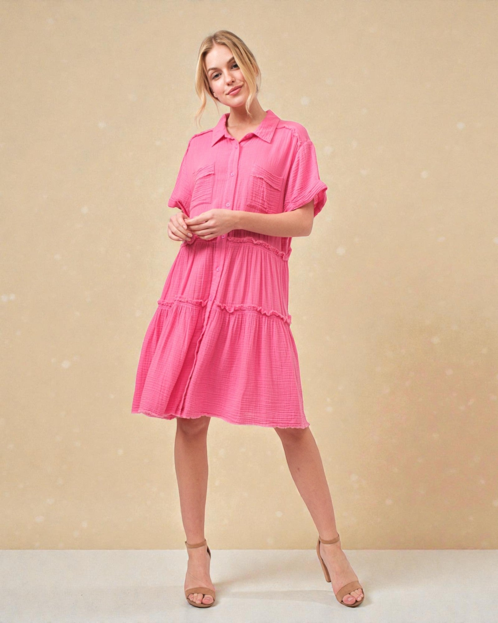 Woman wearing a pink dress against a beige background