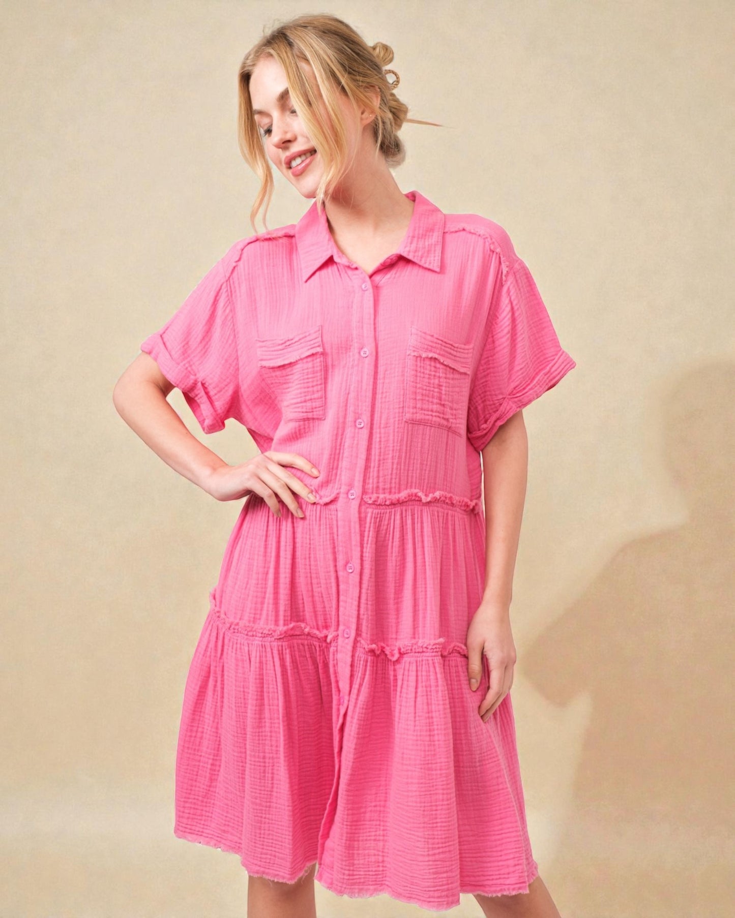 Woman wearing a pink dress against a beige background