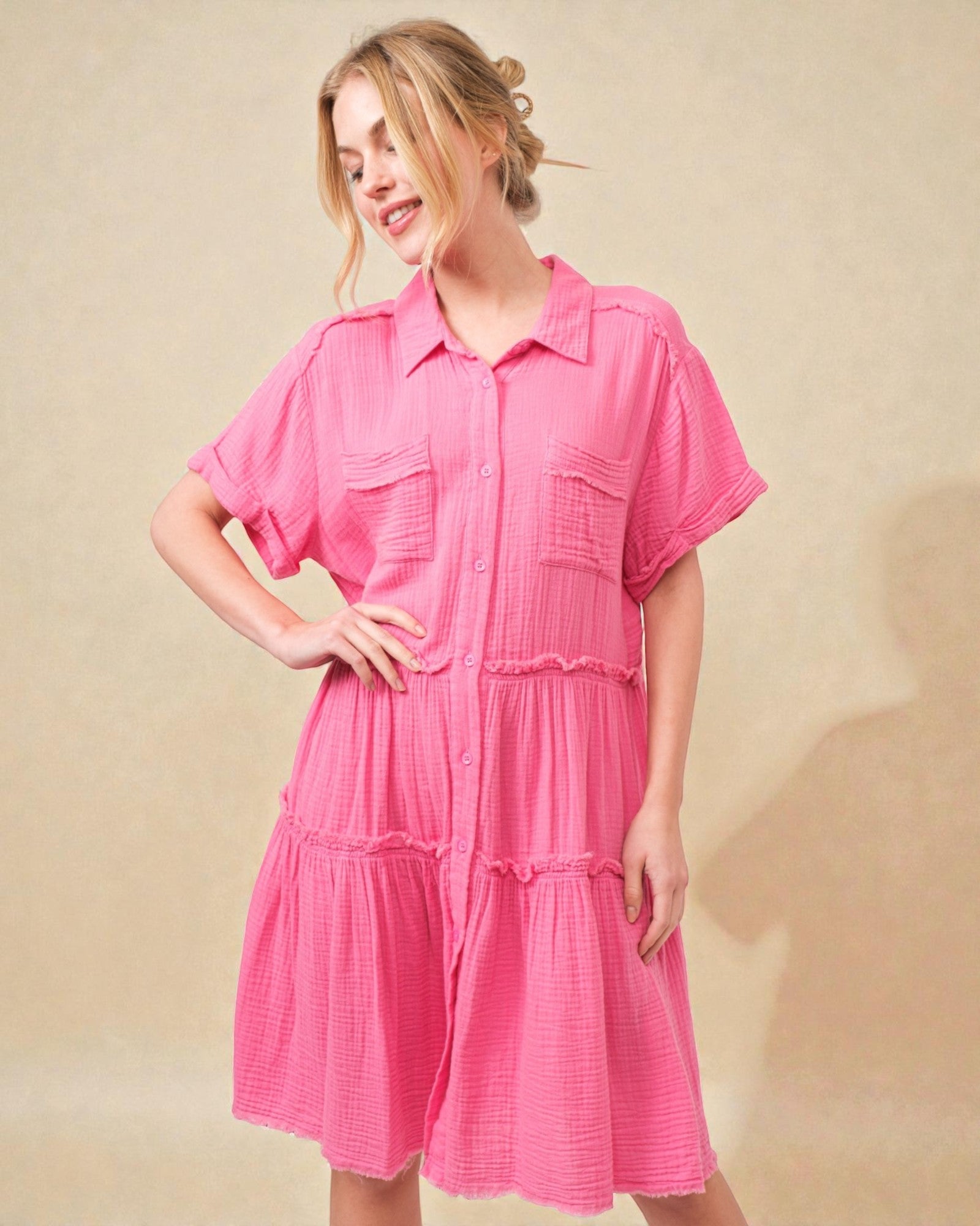 Woman wearing a pink dress against a beige background