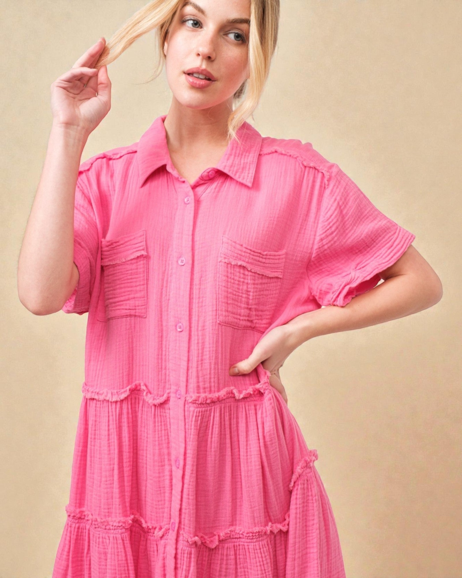 Woman wearing a pink dress against a beige background