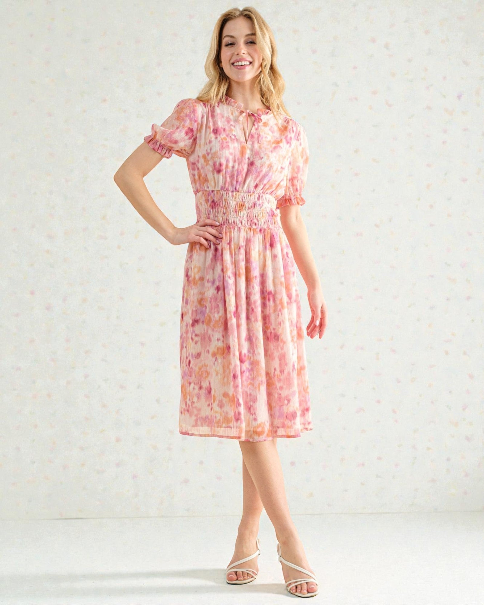 Woman wearing a floral dress against a light background