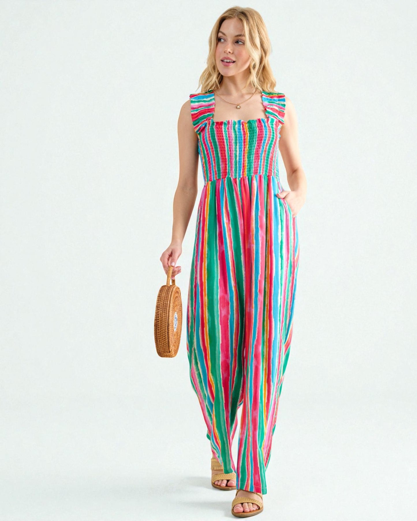 Woman wearing a colorful striped jumpsuit on a white background