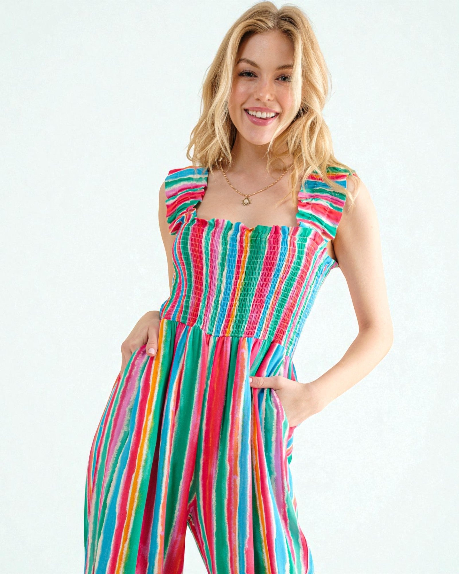 Woman wearing a colorful striped dress on a white background