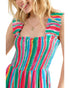Child wearing a colorful striped dress on a white background