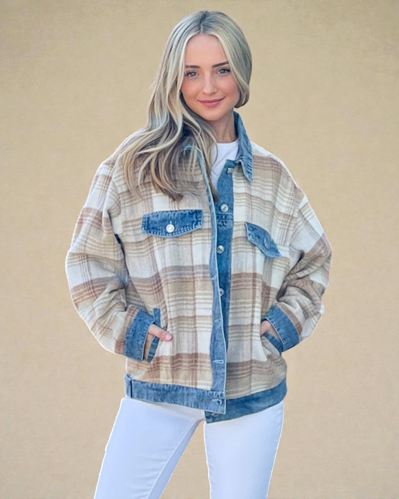 Woman wearing a plaid shirt with denim accents against a beige background