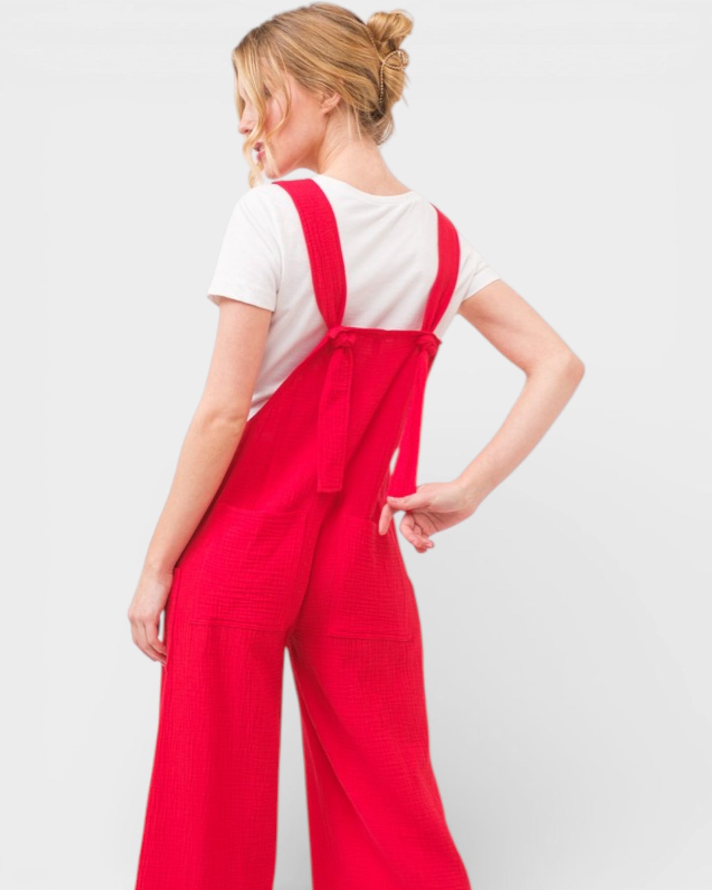 Person wearing a red jumpsuit with a white background