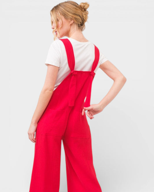 Person wearing a red jumpsuit with a white background