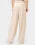 Beige wide-leg pants worn by a person on a light gray background