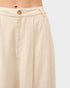 Beige pants with a button detail on a white background