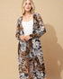Woman wearing a long, patterned robe against a beige background