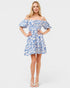 Woman wearing a blue floral dress on a white background