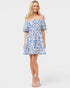 Woman wearing a blue floral dress on a white background