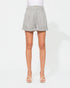 Person wearing gray shorts on a white background