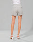Person wearing light gray shorts on a gray background