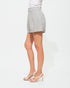 Person wearing a gray skirt on a white background