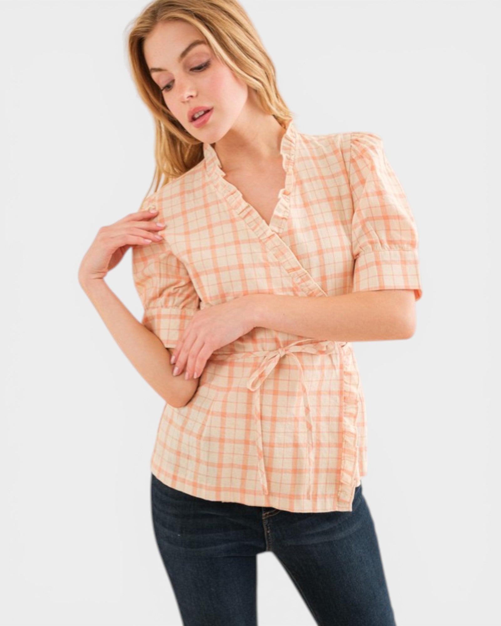 Woman wearing a plaid shirt with a white background