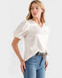 Woman wearing a white blouse and blue jeans with a Gucci belt on a white background