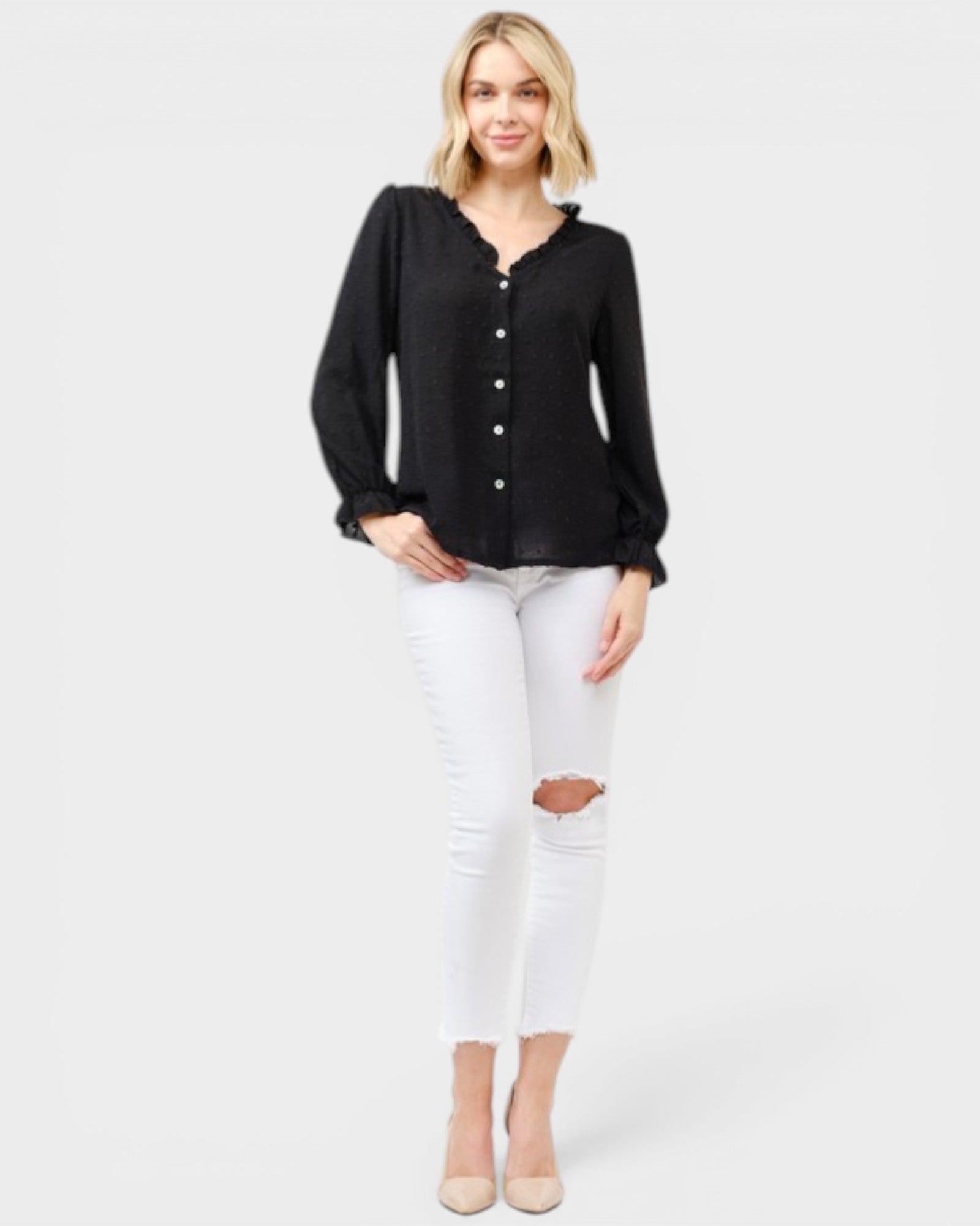 Woman wearing a black blouse and white jeans on a white background