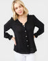 Woman wearing a black button-up shirt with a white background