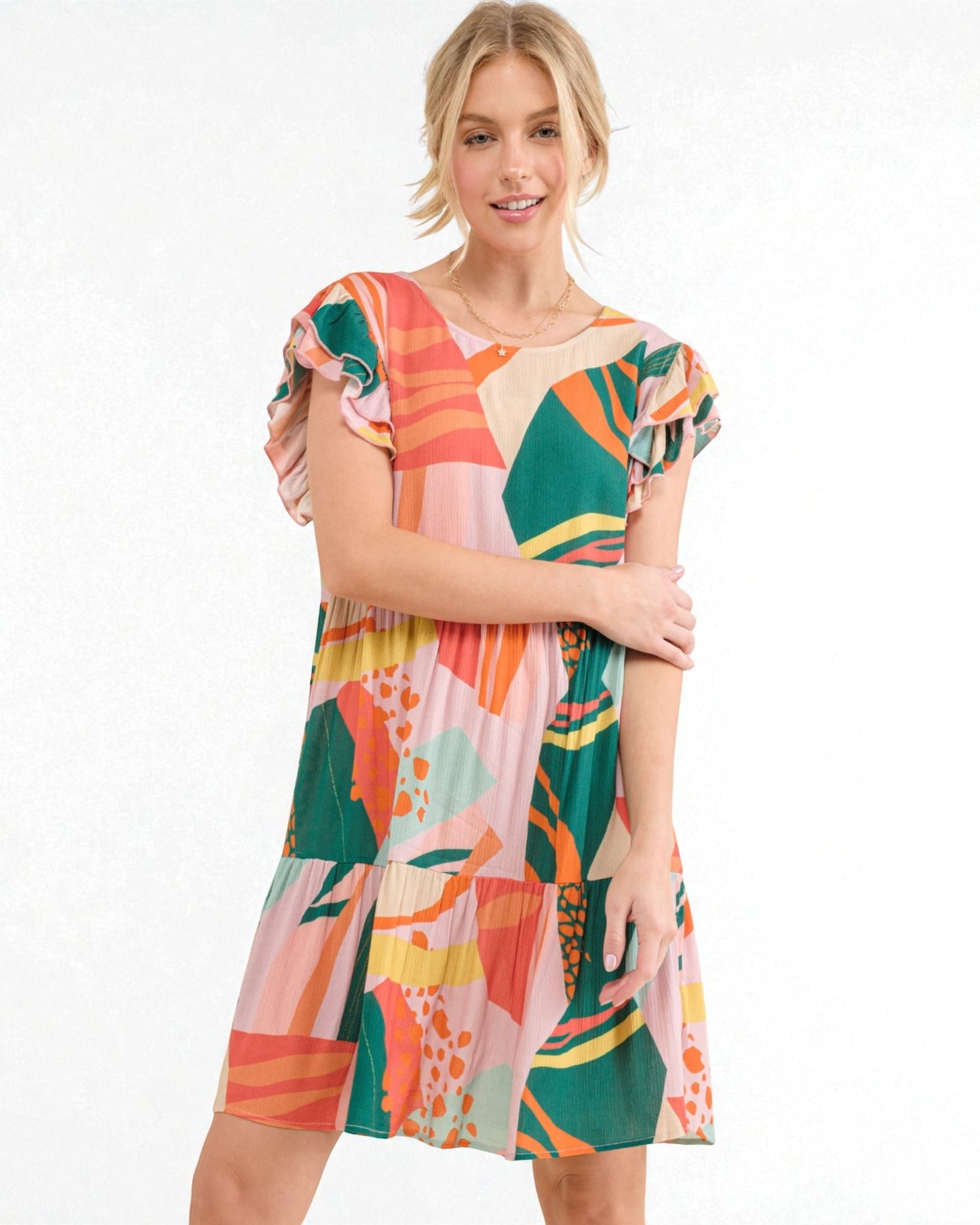Woman wearing a colorful patterned dress on a white background